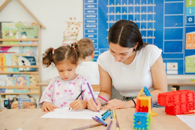 An educational psychologist supporting a young child with a classroom activity